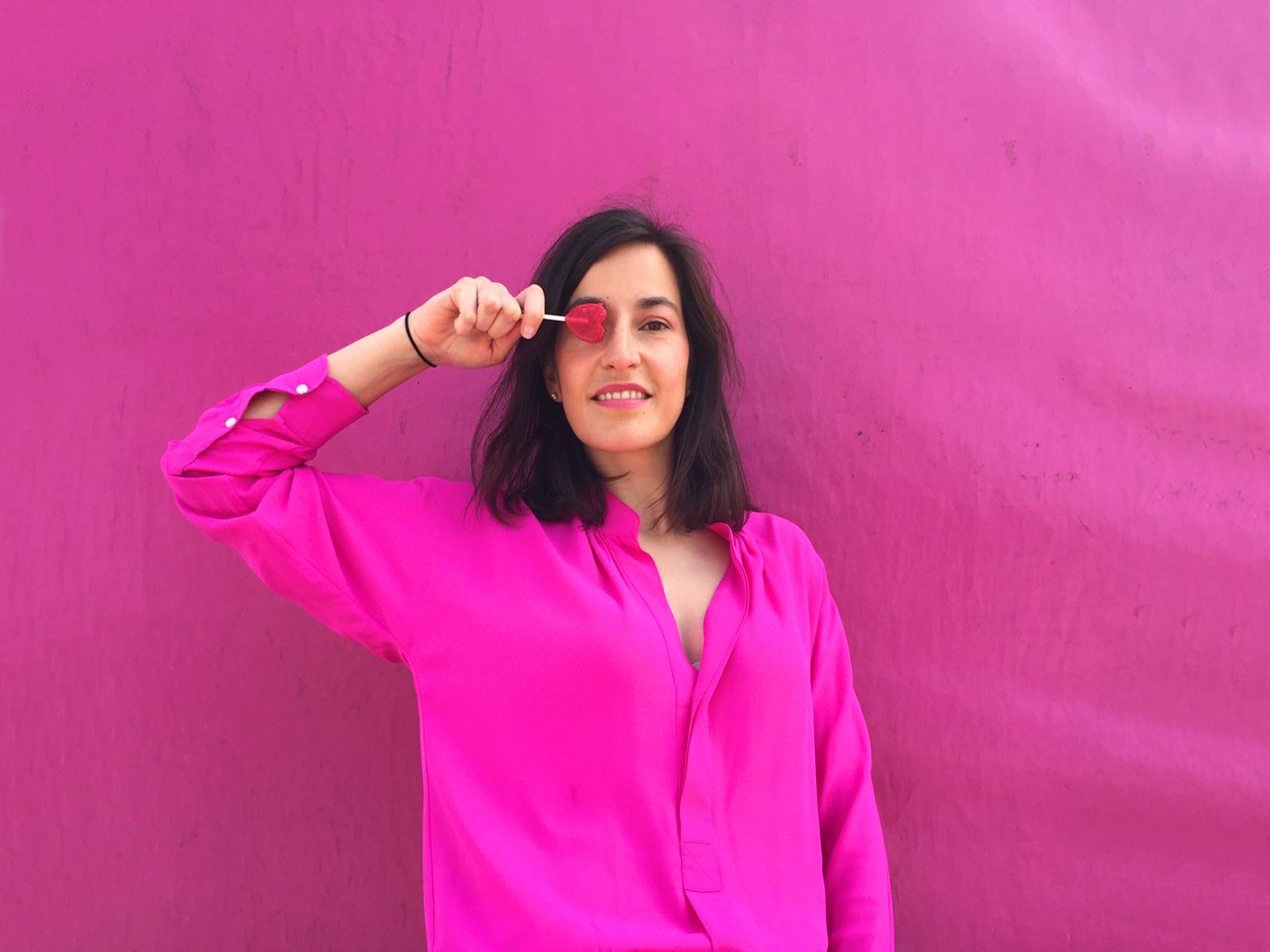 Style Indigo wearing a pink dress as a shirt to achieve the 30 wears challenge with a lolli-pop